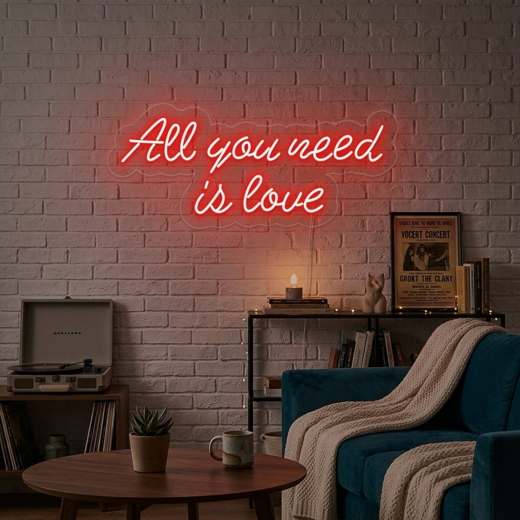 'All You Need is Love' glowing neon sign mounted above a sofa in a modern, stylish living room setting.