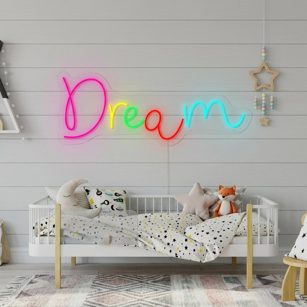 A lifestyle photo showing the glowing 'Dream' script neon sign hanging on a textured wall in a styled kid's bedroom, casting a soft glow over a made bed and decorative items.