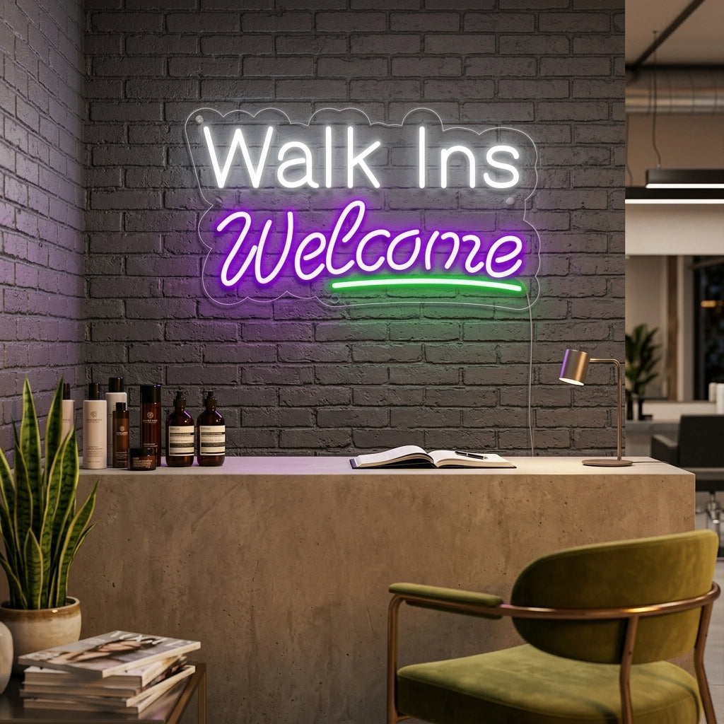 A lit "Walk Ins Welcome" neon sign in script font, glowing pink and mounted on a textured brick wall in a busy retail environment.