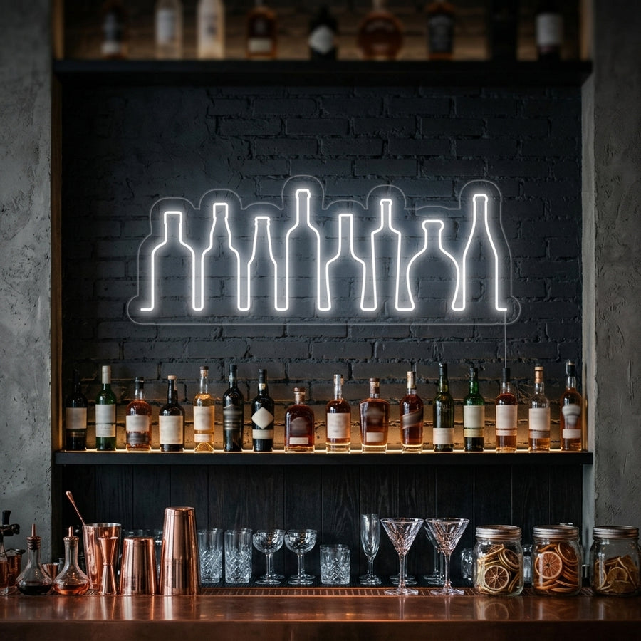 A vibrant 'Bar Bottles' neon sign glowing red, orange, and white above a fully stocked home bar.
