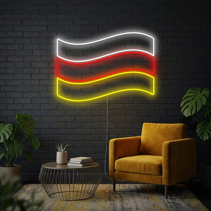 Vibrant Germany flag neon sign glowing against a brick wall in a cozy living room setting.