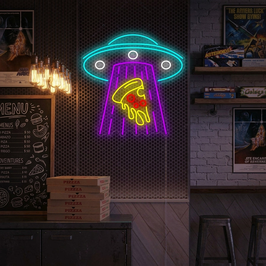 A vibrant 'Ufo Kidnapping Pizza' neon sign, glowing brightly and mounted on a textured brick wall in a cozy bar or restaurant setting.