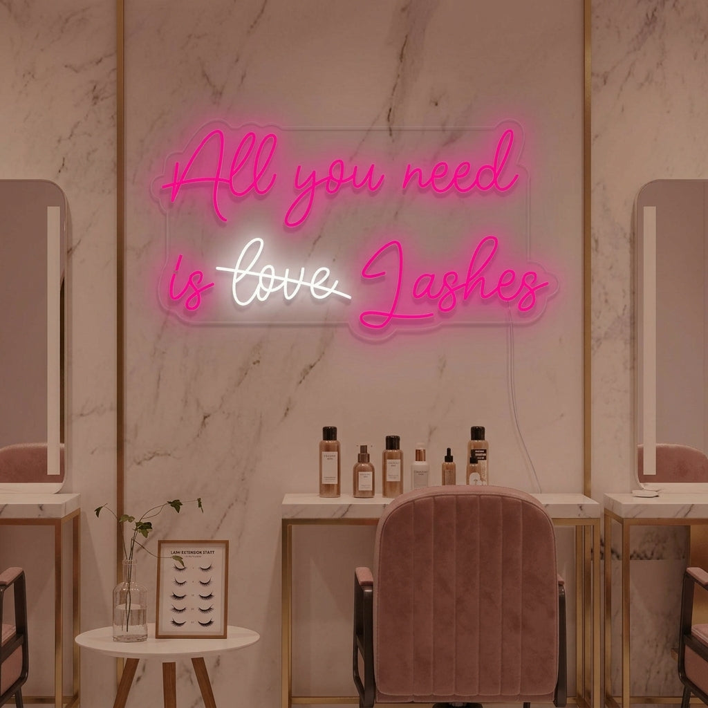 Vibrant "All You Need Is Lashes" neon sign displayed on a salon wall, creating an inviting ambiance for clients.