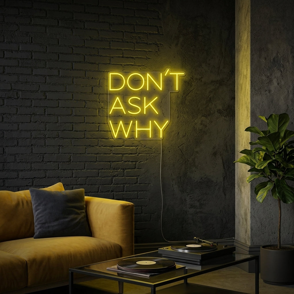 A glowing blue 'Dont Ask Why' custom neon sign hanging on a dark gray painted wall in a modern living space.