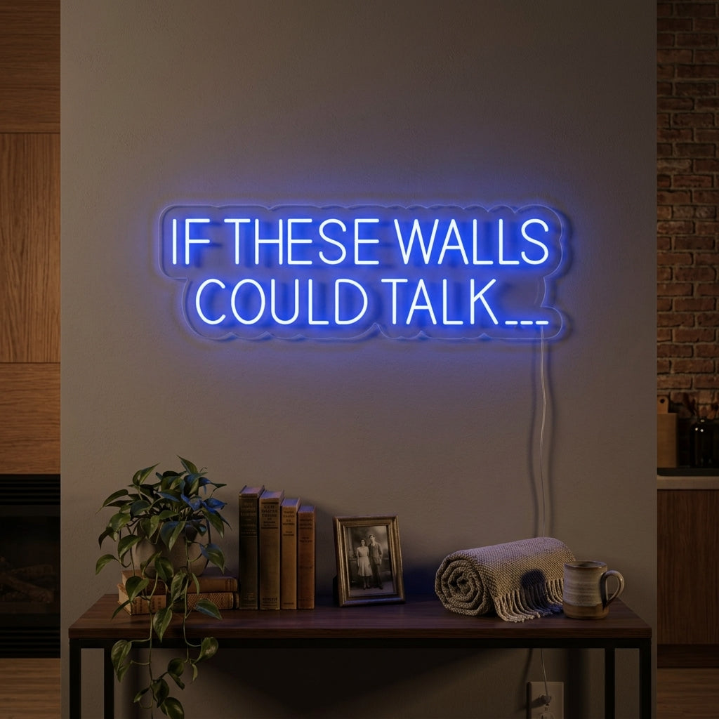 A cozy living room featuring the illuminated "If These Walls Could Talk" neon sign on a textured brick wall, with a comfortable armchair and house plants below.