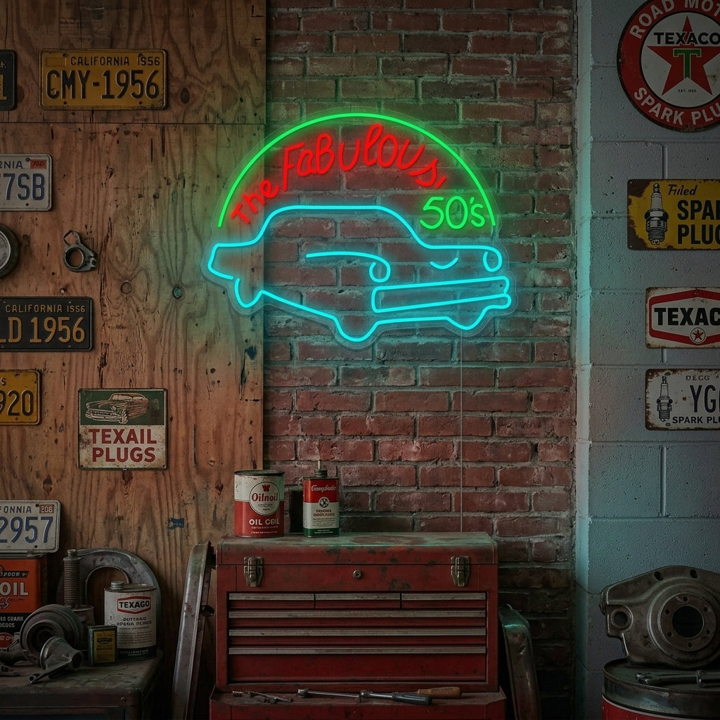 A vibrant 'Fabulous 50S For Garage' neon sign glowing red and white on a textured brick wall in a rustic workshop setting.