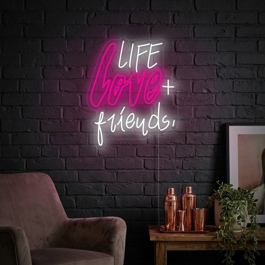 A glowing 'Life Love Friends' white neon sign in script font, mounted on a rustic wooden wall in a modern living room setting.