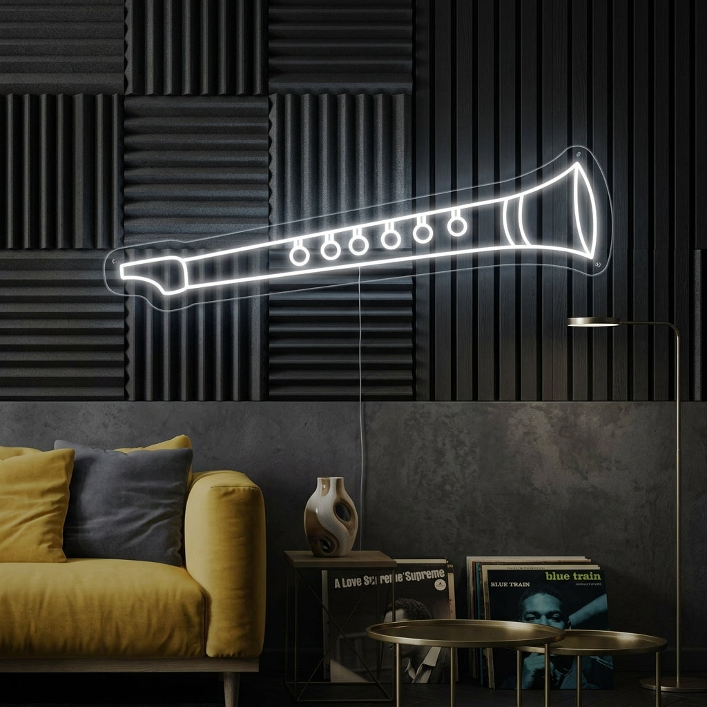 A glowing Flute Neon Sign displayed as unique wall art above a desk in a creative studio.