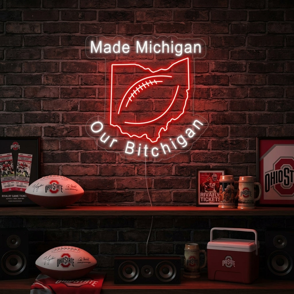 The glowing "Made Michigan Our Bichigan Football" neon sign displayed on a textured wall in a modern living space.