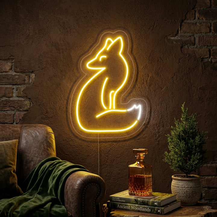 A cozy living room wall featuring a glowing orange neon sign in the shape of a fox's head, mounted above a velvet sofa.