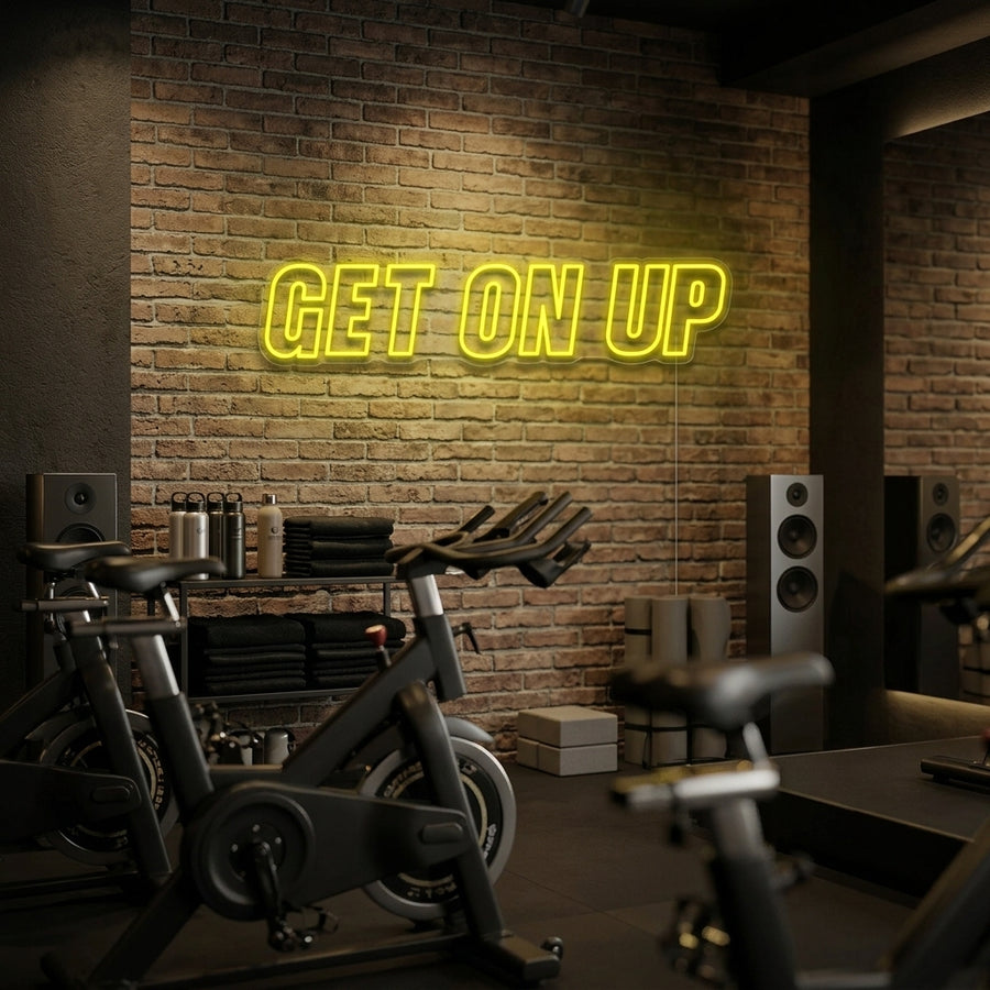A vibrant 'Get On Up' neon sign providing a motivational glow in a modern home gym setting above some weights.