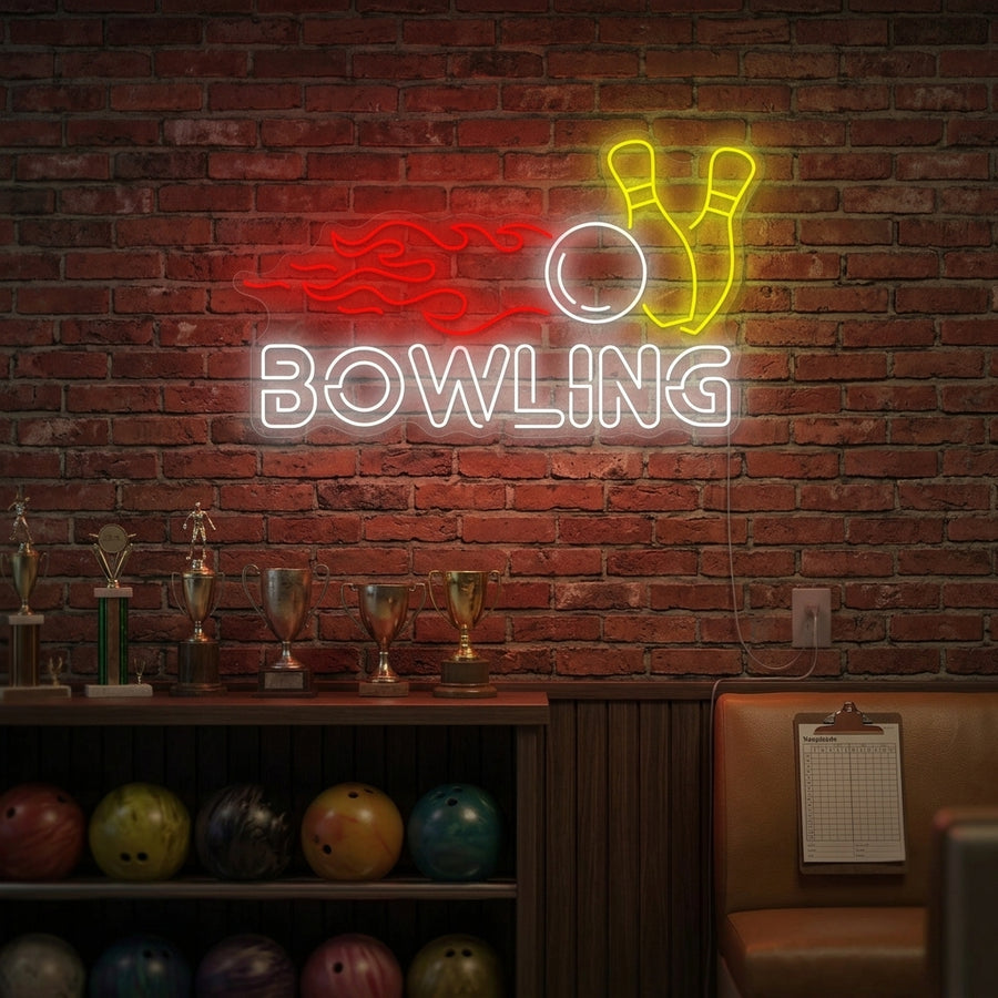 A glowing blue neon sign depicting a bowling ball hitting ten pins on a lane wall above a leather sofa.