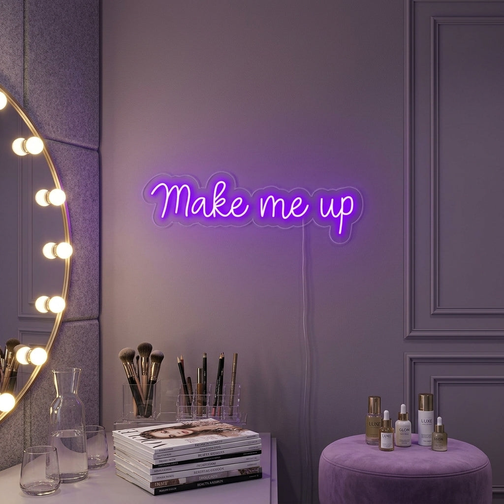 The 'Make Me Up' neon sign is lit, casting a warm white glow from a decorative concrete wall inside a stylish makeup or beauty studio setting.