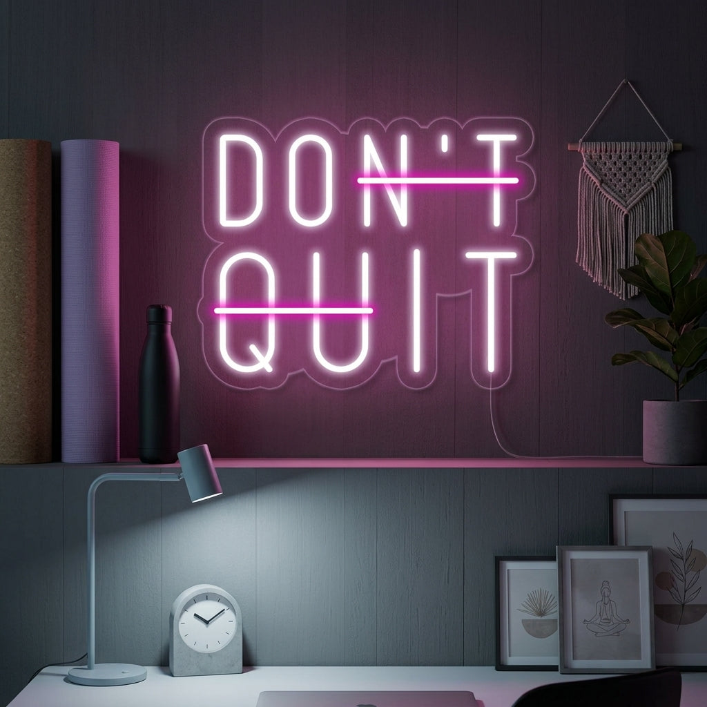 Motivational 'Dont Quit Do It' neon sign glowing on a textured brick wall in a cozy home office setting.