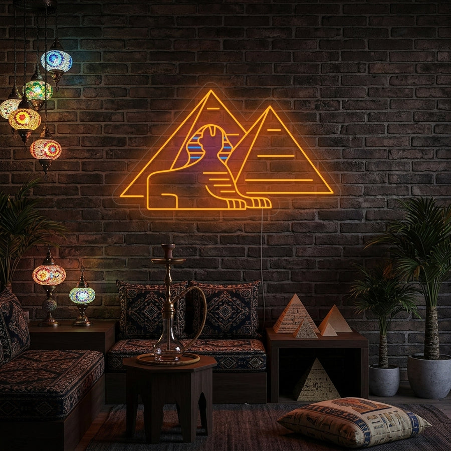 A stunning lifestyle photograph of the illuminated Sphinx Egyptian Pyramids Neon Sign glowing above a modern desk in a home office.