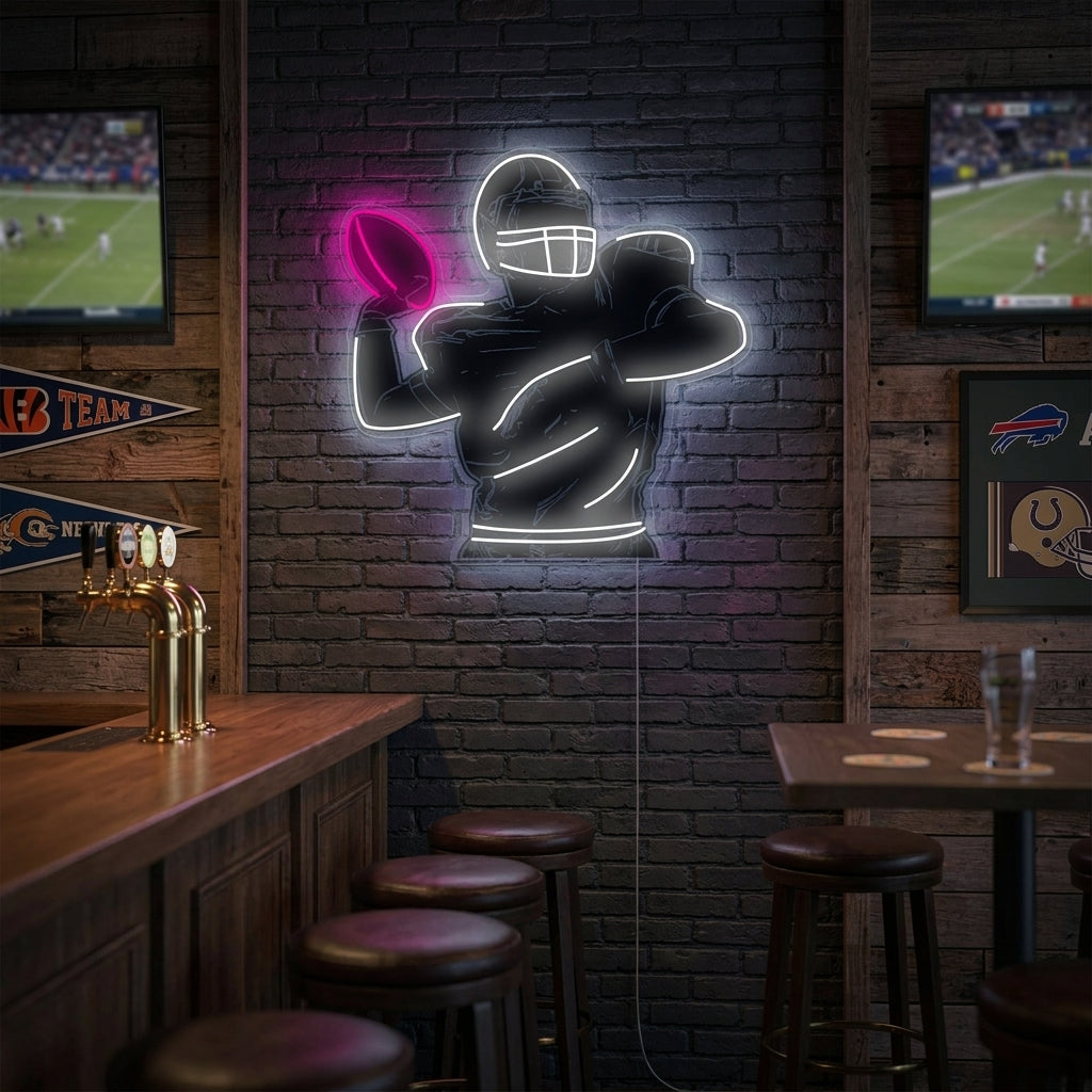 A glowing abstract neon sign depicting an American football player in action mounted on a dark brick wall in a rustic game room setting.