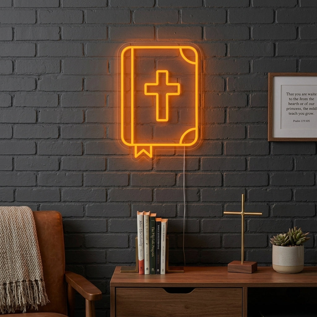 A lifestyle photograph showcasing a detailed Christian Holy Bible neon sign glowing warmly on a wall above a wooden table.
