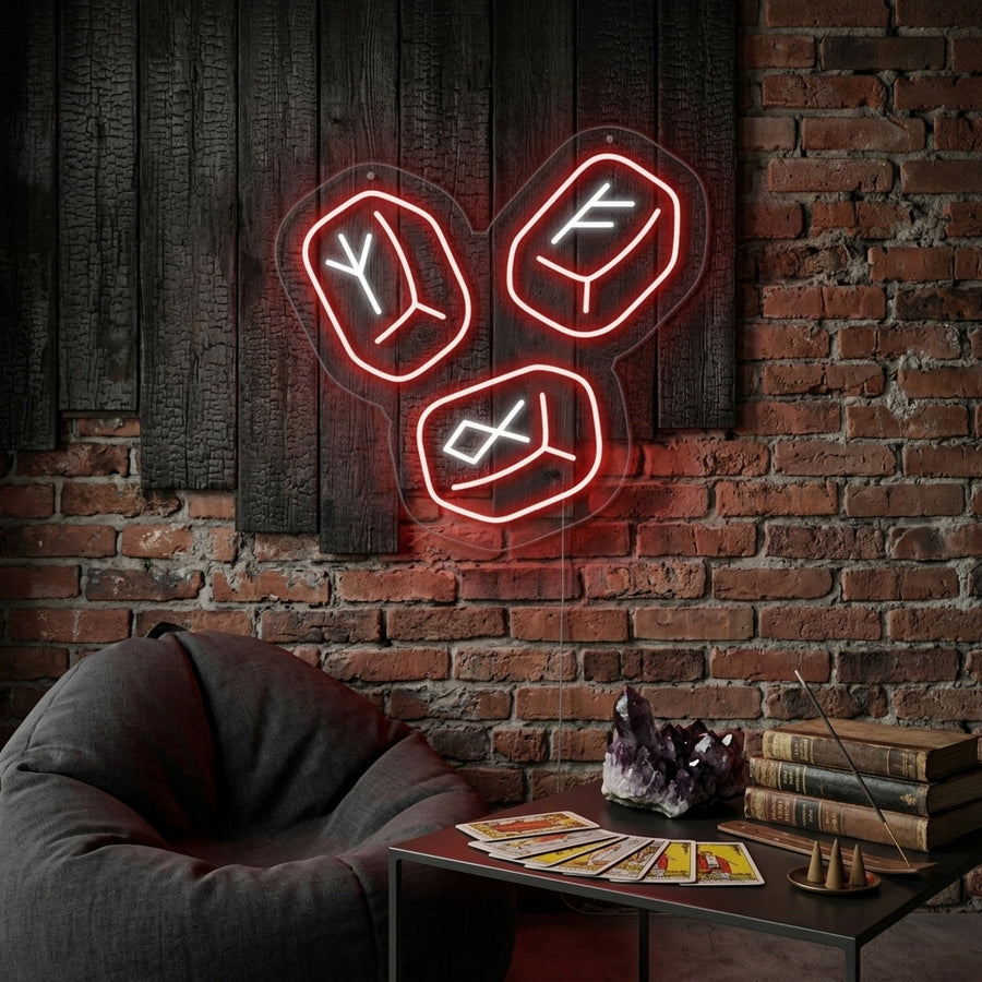 A lifestyle photograph of a dimly lit, cozy room where a glowing Nordic Runestones Neon Sign illuminates the wall with blue light. It is positioned above a rustic shelf with ancient artifacts and potted plants.
