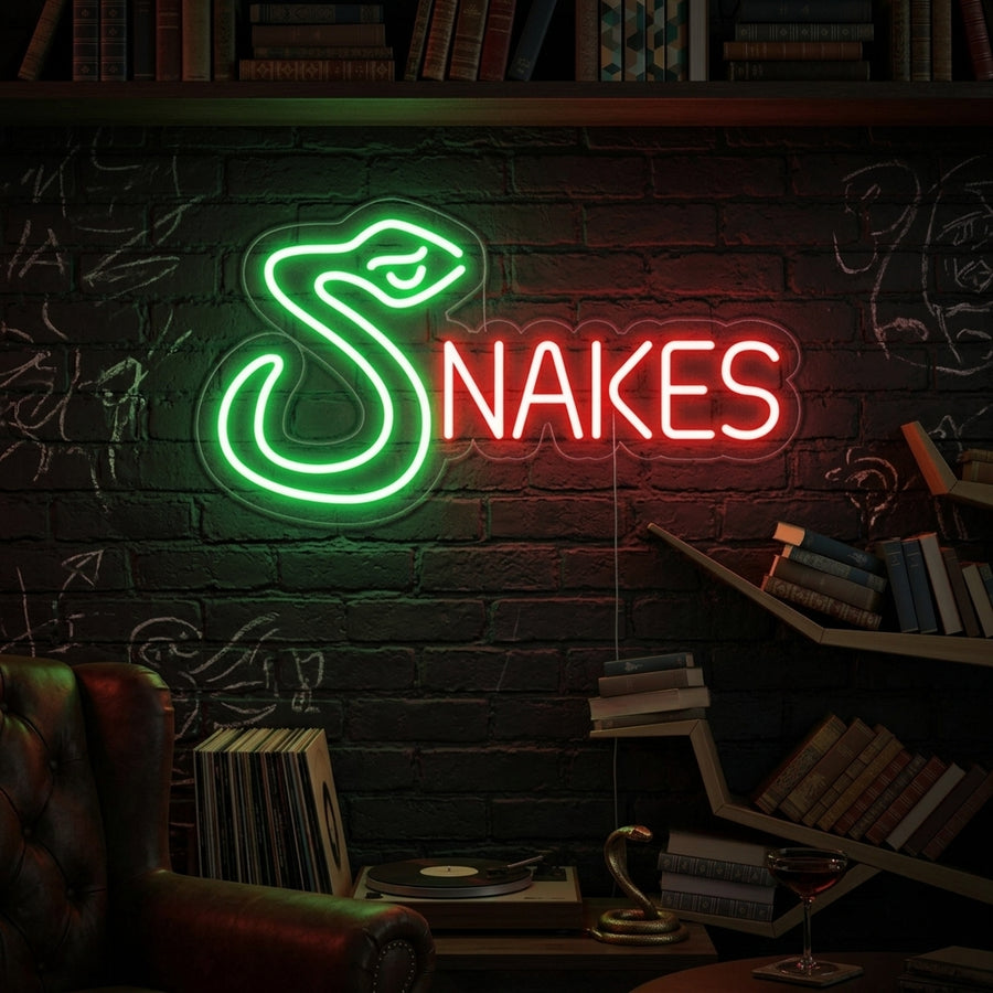A vibrant 'Snakes' neon sign glowing brightly on a textured wall, showcasing its artistic dual serpent design and adding character to a styled modern interior.