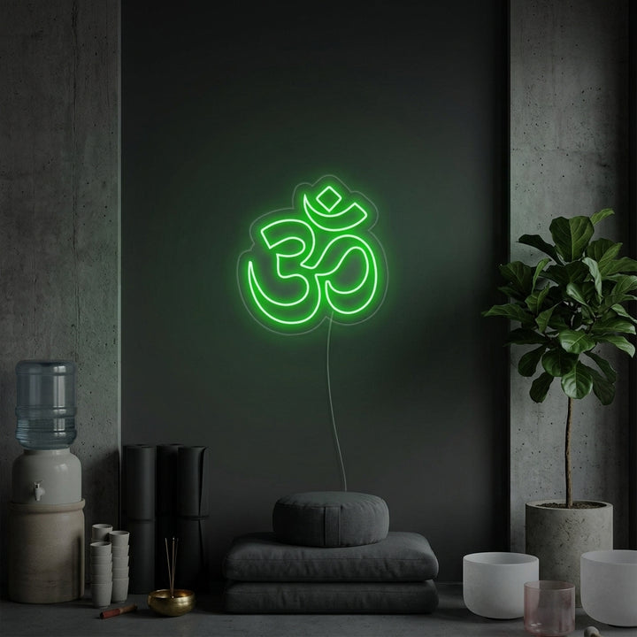 A glowing blue Om symbol neon sign illuminates a serene yoga studio setting with mats, blocks, and plants.