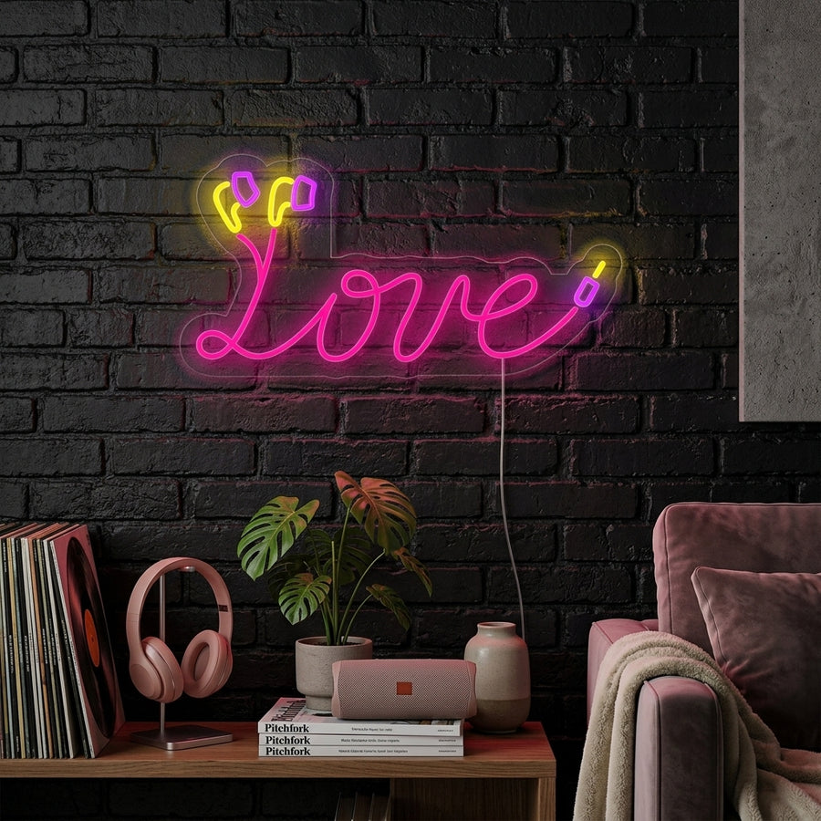 A cozy bedroom with a neon sign on the wall that glows in the shape of a heart formed by an earphone cable.