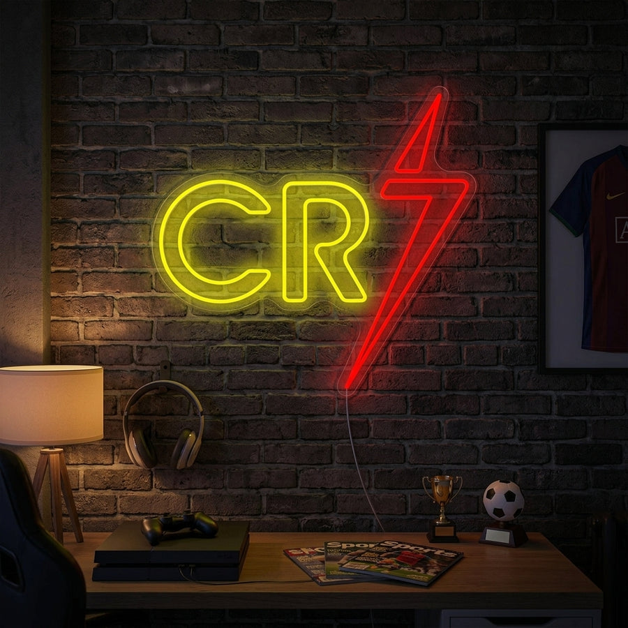 A lifestyle photo showing the CR7 neon sign glowing brightly above a cozy sofa, creating a warm, focused atmosphere in a sports-themed living room.