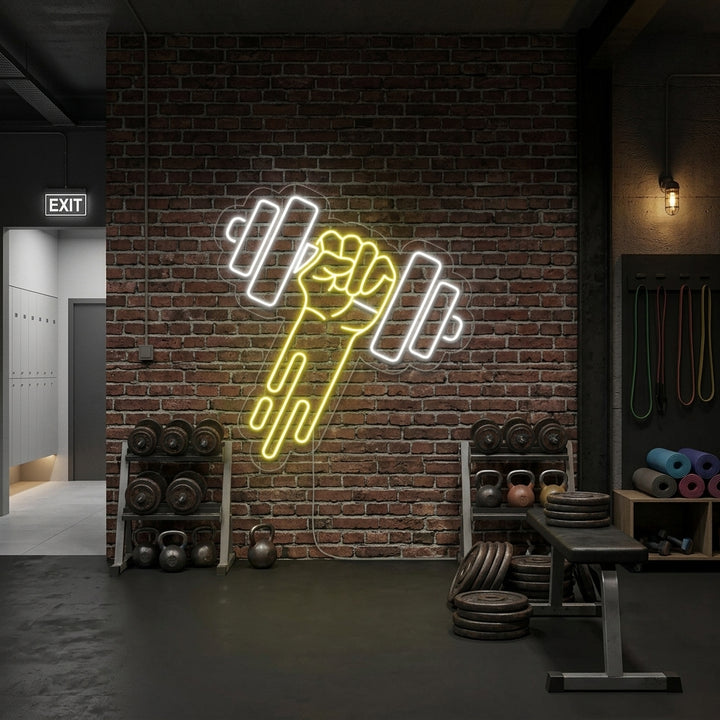 A vibrant 'Gym Dumbbell' neon sign glowing brightly above a weights bench in a modern fitness studio.