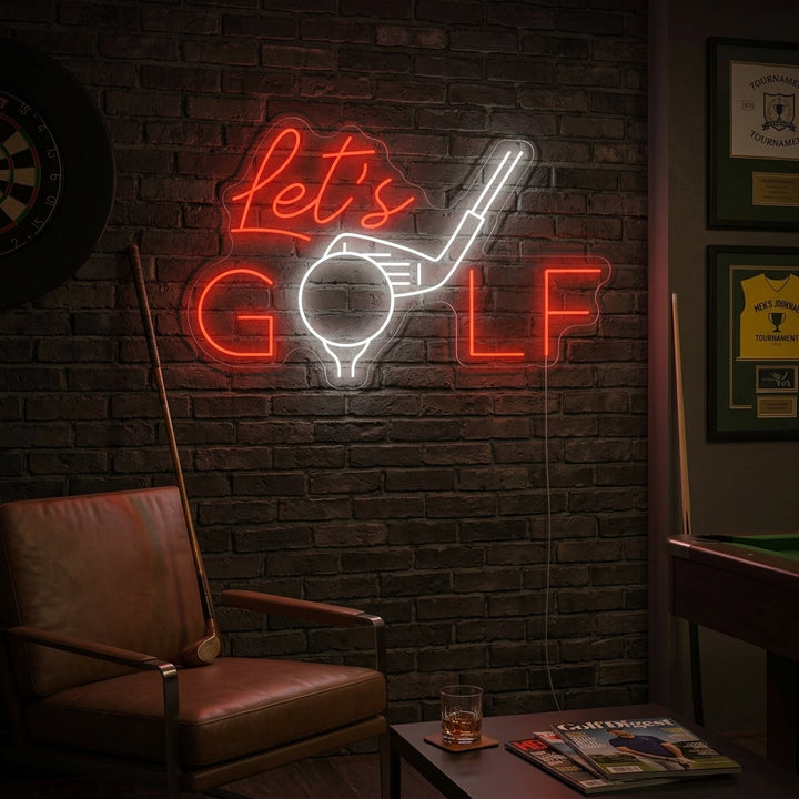 A Let's Golf neon sign featuring a golfer in mid-swing, displayed as wall art above a bar cart with golf memorabilia in a cozy man cave setting.