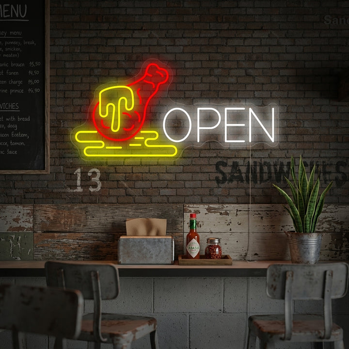 A glowing 'Open Chicken' neon sign featuring a green chicken graphic and yellow 'OPEN' text, mounted on a rustic wooden wall above a cozy restaurant booth.