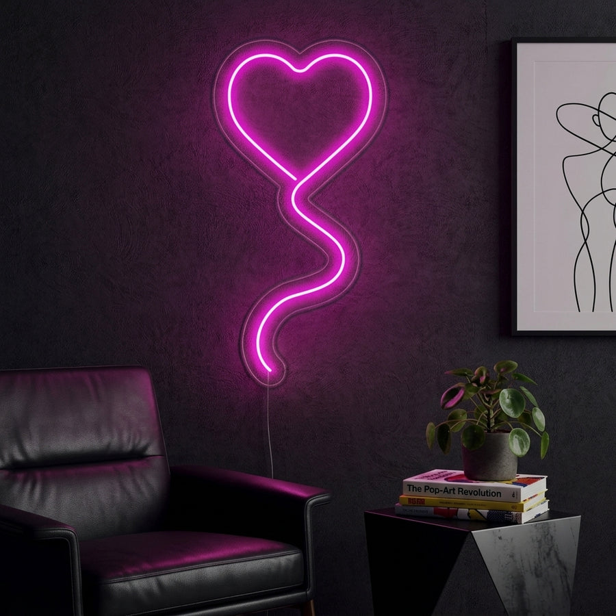 A vibrant pink neon wall sign shaped like a whimsical twisted balloon heart, illuminating a cozy and stylishly decorated room backdrop.