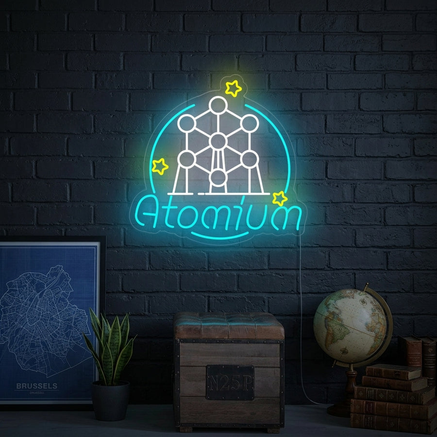 A glowing Belgium Atomium Brussels neon sign mounted above a wooden desk and chair.