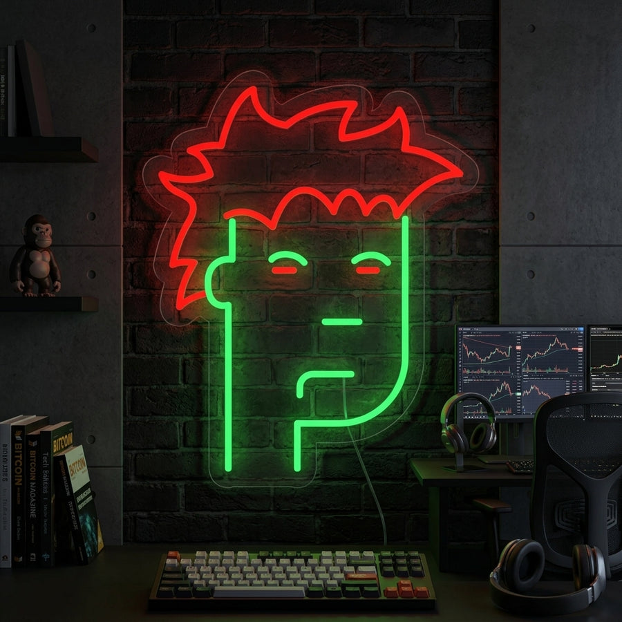 A glowing blue NFT Monkey neon sign displayed prominently above a dark wooden desk in a modern office setup with plants.