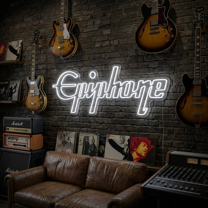 A glowing Epiphone neon sign featuring the classic script logo, mounted on a rustic wooden wall above a vintage electric guitar on a stand and a small amplifier.