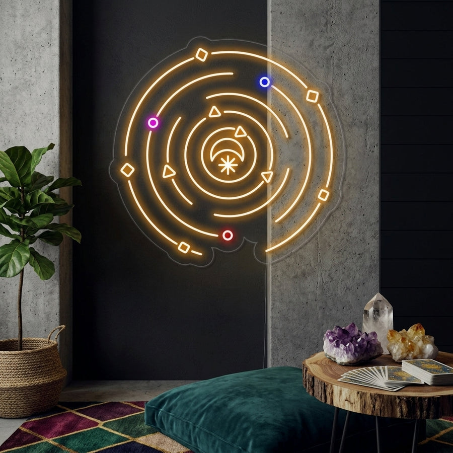 Vibrant glowing neon sign of a sun, crescent moon, and stars on a complex orbital path, mounted on a stone wall over a modern desk in a celestial-themed office
