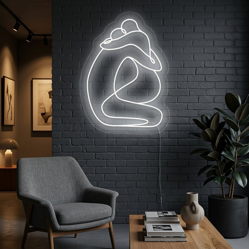 A stylish 'Abstract Lovers Embrace' neon sign mounted on a textured living room wall above a modern credenza and plant, glowing with warm light.