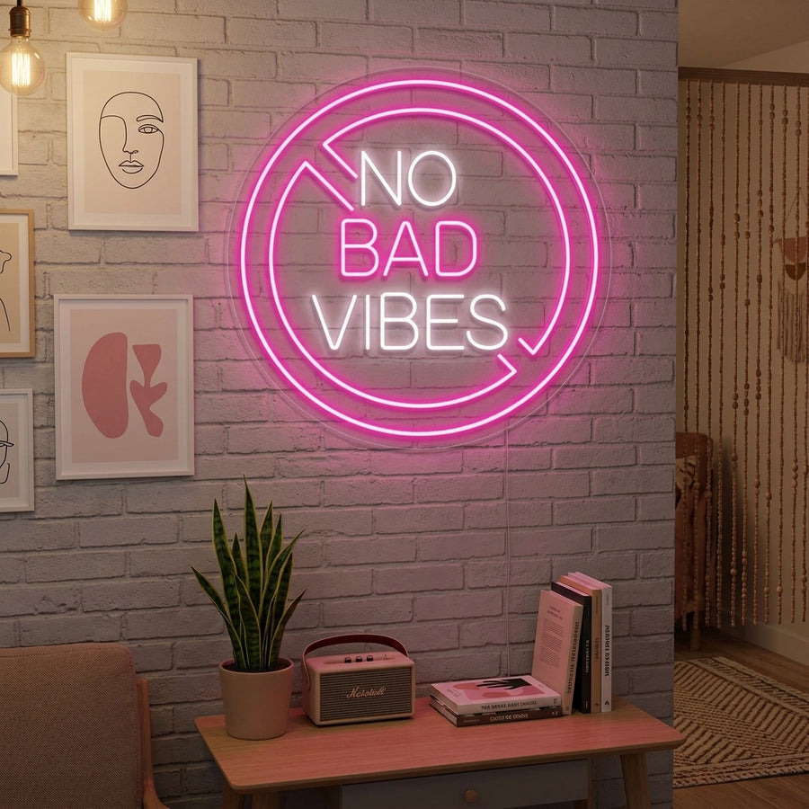 An illuminated 'No Bad Vibes' neon sign glowing in a cozy bedroom setting above a made bed and stylish decor, casting a pleasant glow on the surroundings.