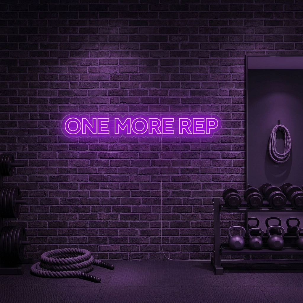 A vibrant 'One More Rep' neon sign glowing on a textured gym wall, motivating a workout.