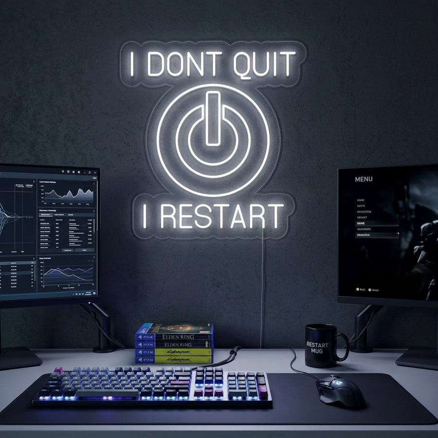 A candid lifestyle shot of the lit 'I Don't Quit I Restart' neon sign in orange script and white block letters, mounted on a rustic wood plank wall above a desk.