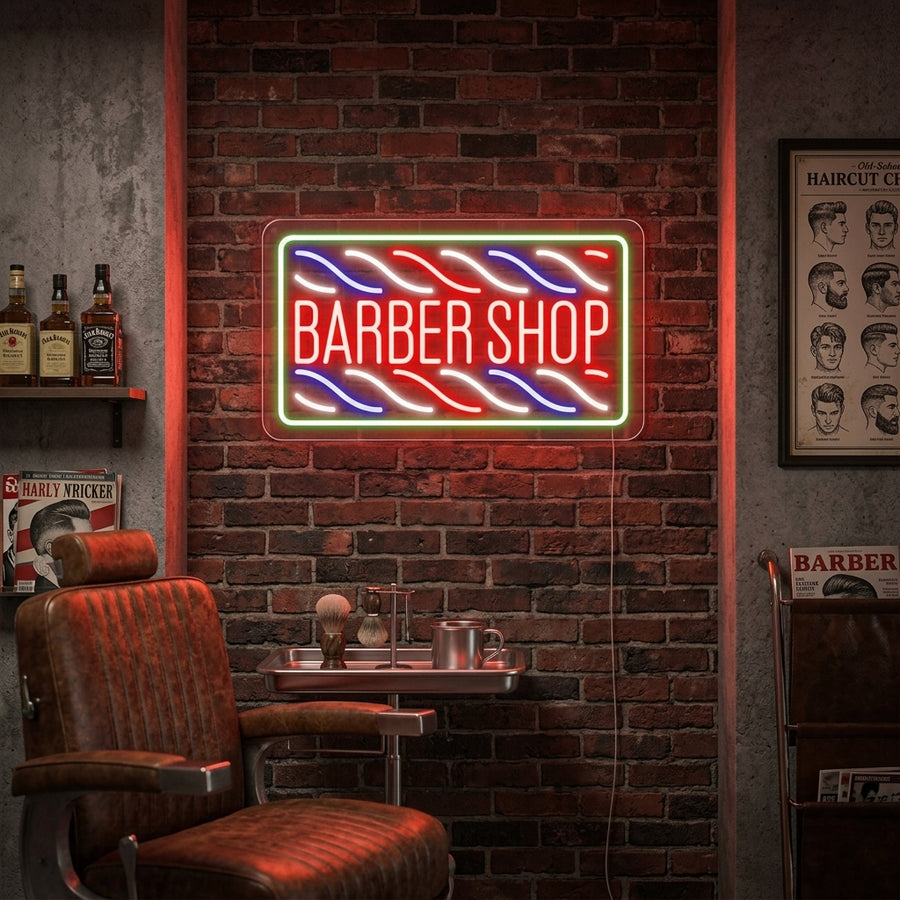 A 'Barbershop' neon sign glowing red on an exposed brick wall, above a wooden vanity with barber tools and a mirror in a classic barbershop.