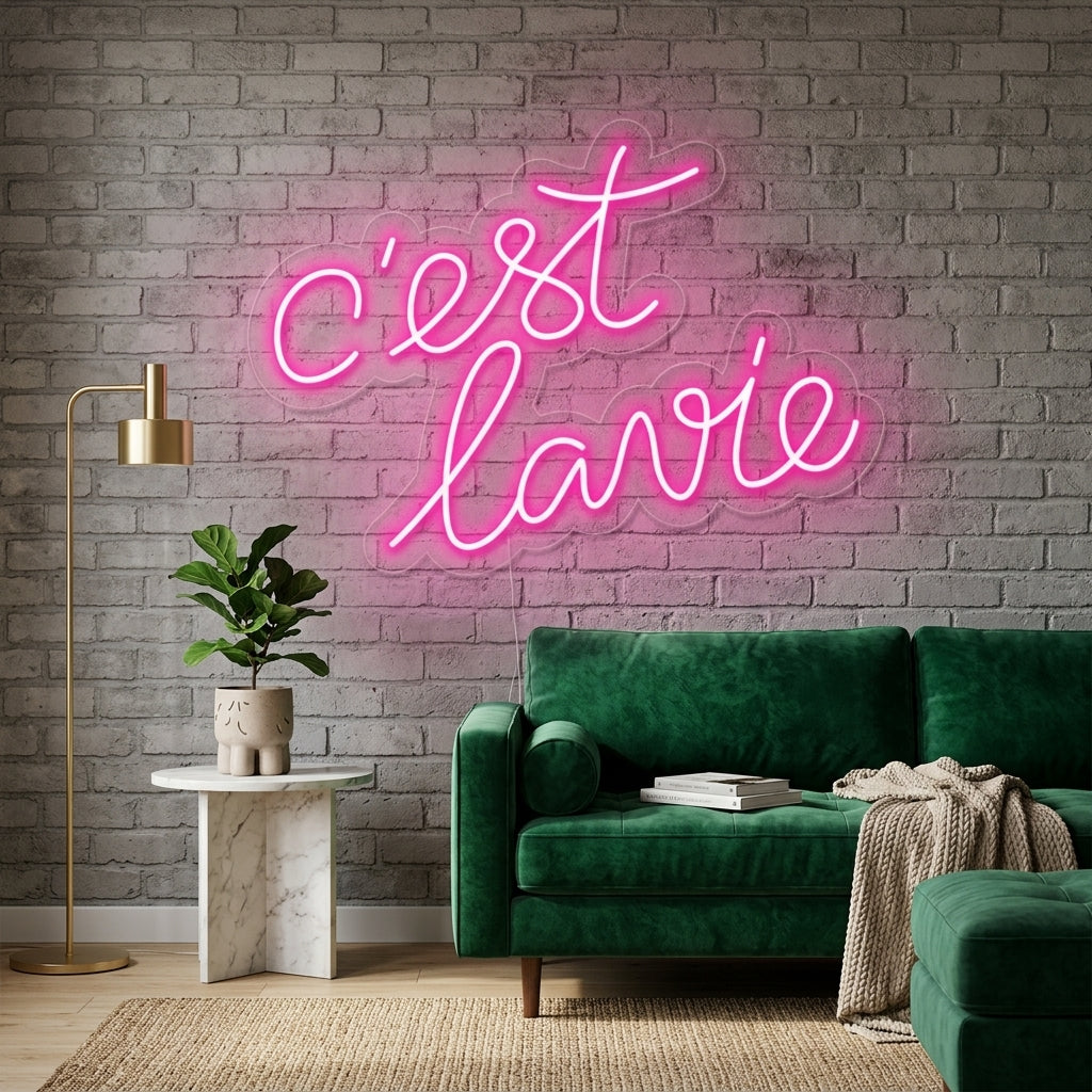 A "Cest lavie" neon sign glowing on a textured apartment wall above a cozy seating area.