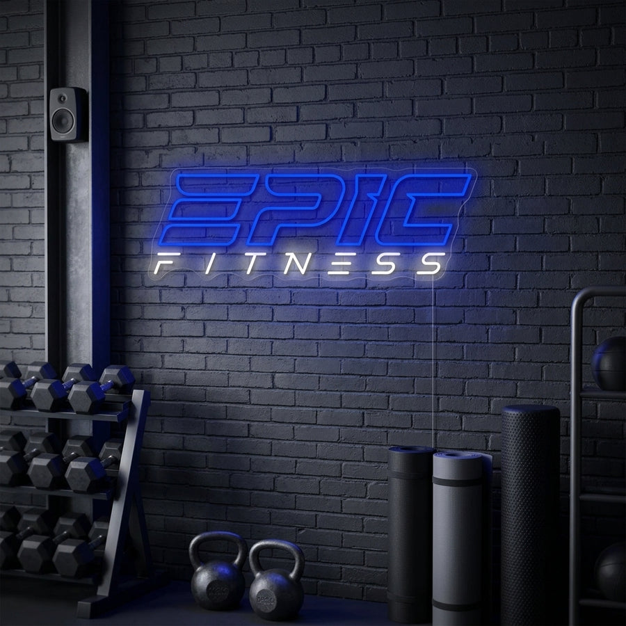 A vibrant 'Epic Fitness' neon sign illuminates a dimly lit home gym interior, providing a motivational glow above workout equipment.