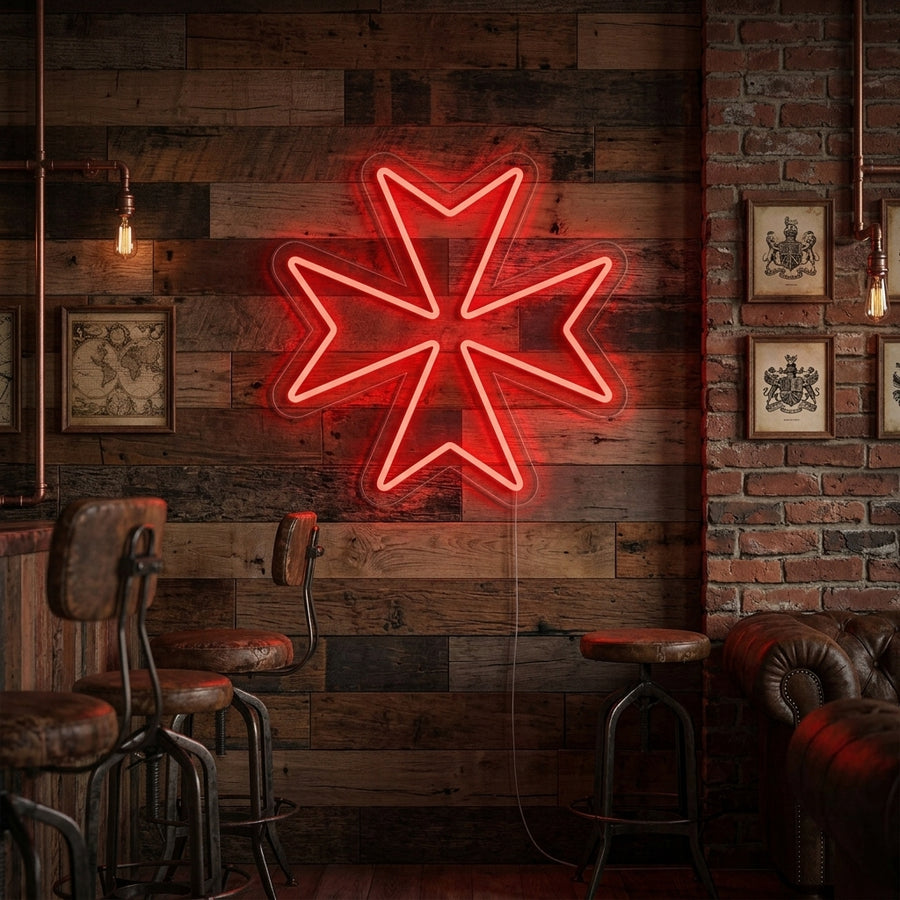 A glowing blue Maltese Cross neon sign mounted on a textured brick wall above a shelf with books in a warm, inviting living space.