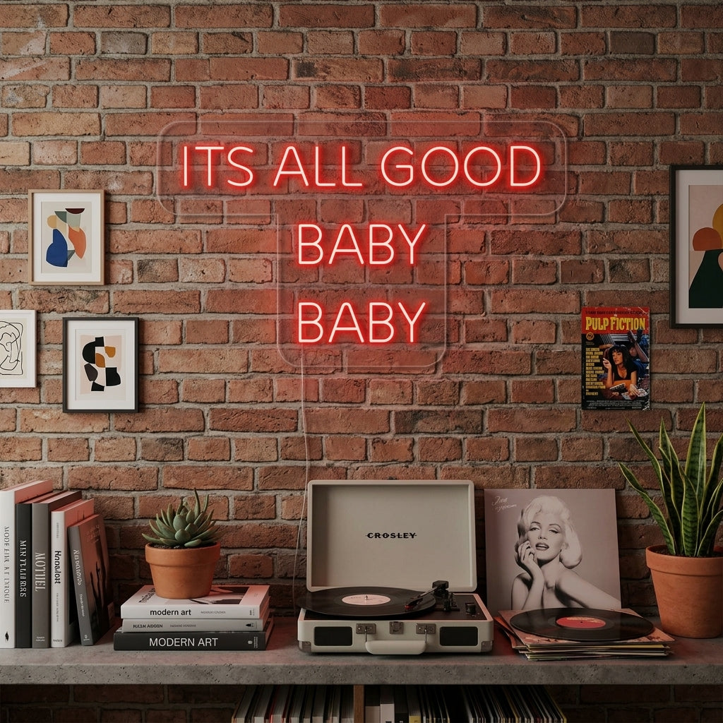 A stylish 'It's All Good Baby Baby' neon sign illuminating a cozy living room, mounted above a plush sofa.