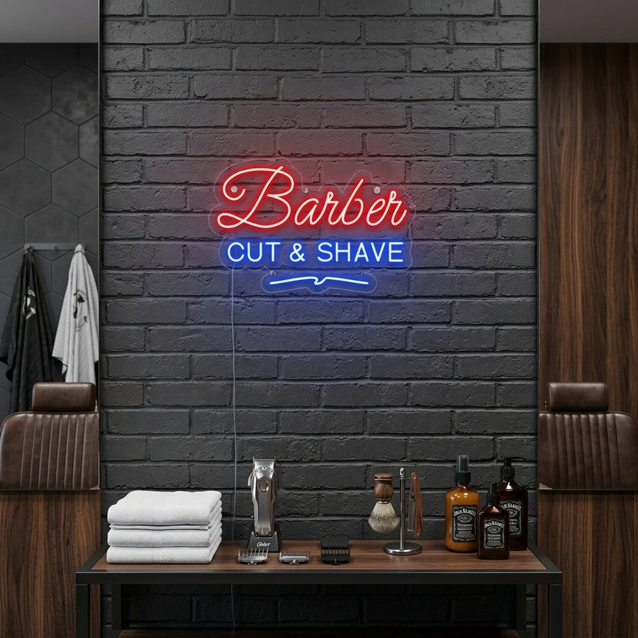 A glowing blue 'BARBER CUT SHAVE' neon sign mounted on a textured brick wall within a stylish, modern barbershop interior, positioned above a barber station.
