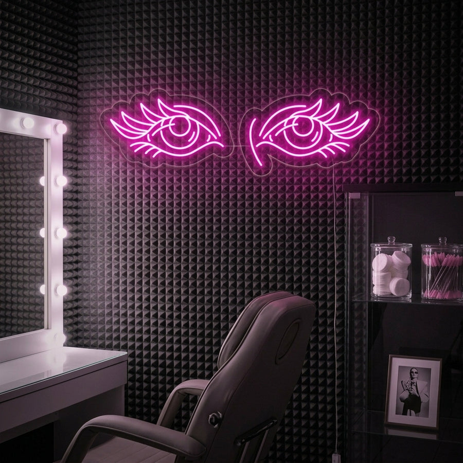 Chic and stylish 'Eyes Lashes' neon sign glowing softly, mounted on a stone textured wall in a modern beauty studio or salon. The warm glow illuminates surrounding beauty products, plants, and a comfortable armchair, creating a trendy aesthetic.