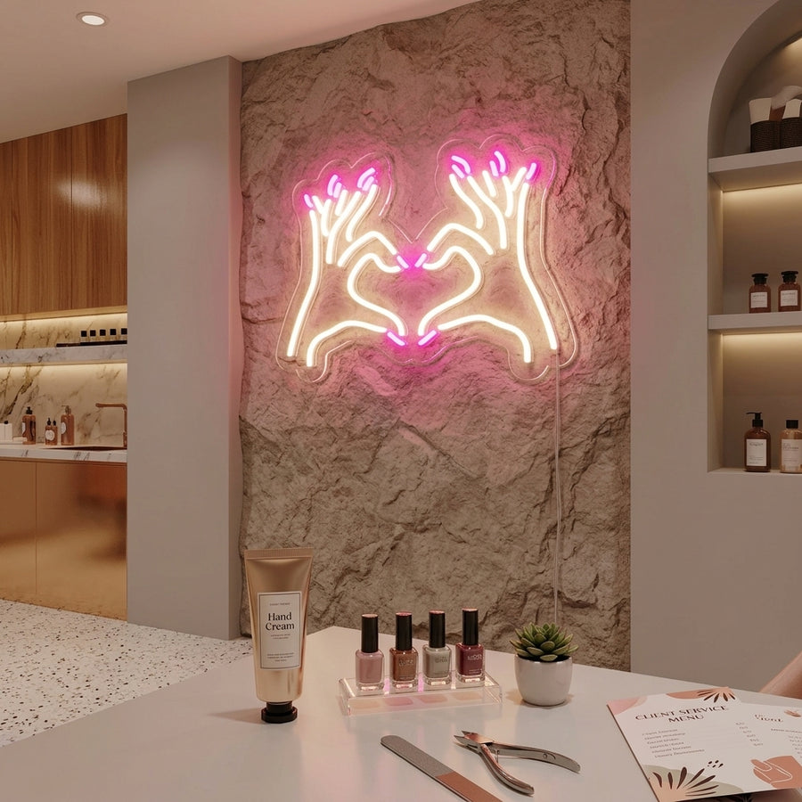A stunning 'Nail Salon' neon sign glows with pink and white light in a modern nail salon setting.
