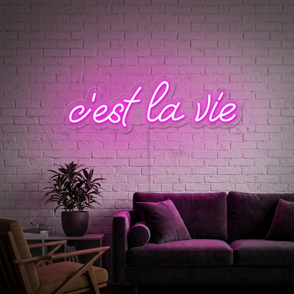 'C'est la vie' neon sign styled on a wall in a living room setting.