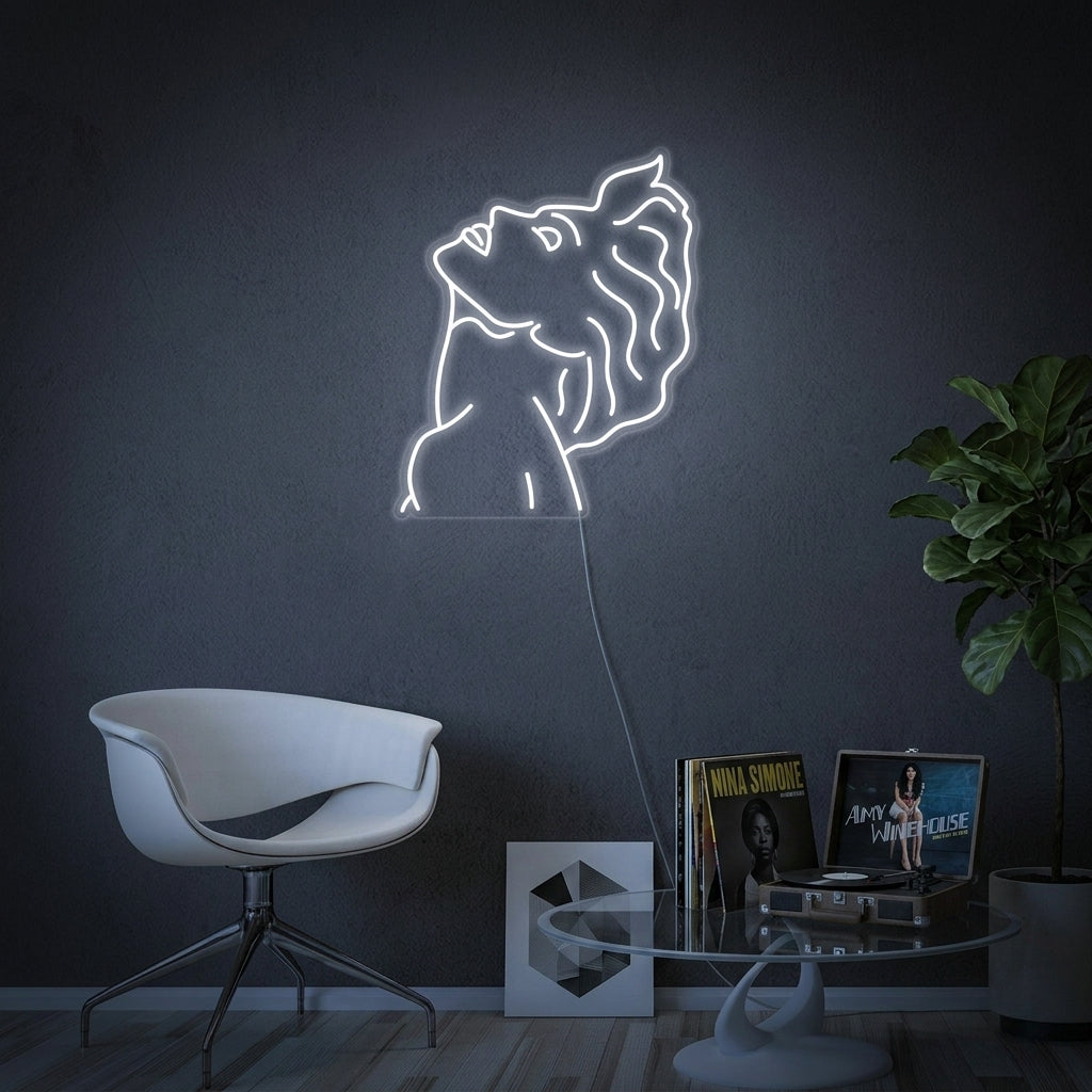 A Pop Art Singer neon sign with an orange silhouette of a person in a crown and a microphone, set against a dark textured wall next to a sofa and plants.