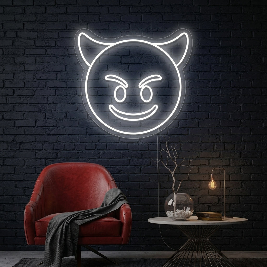 A wall-mounted, smirking purple Evil Emoji neon sign glowing above a dark leather sofa and coffee table in a modern loft environment.
