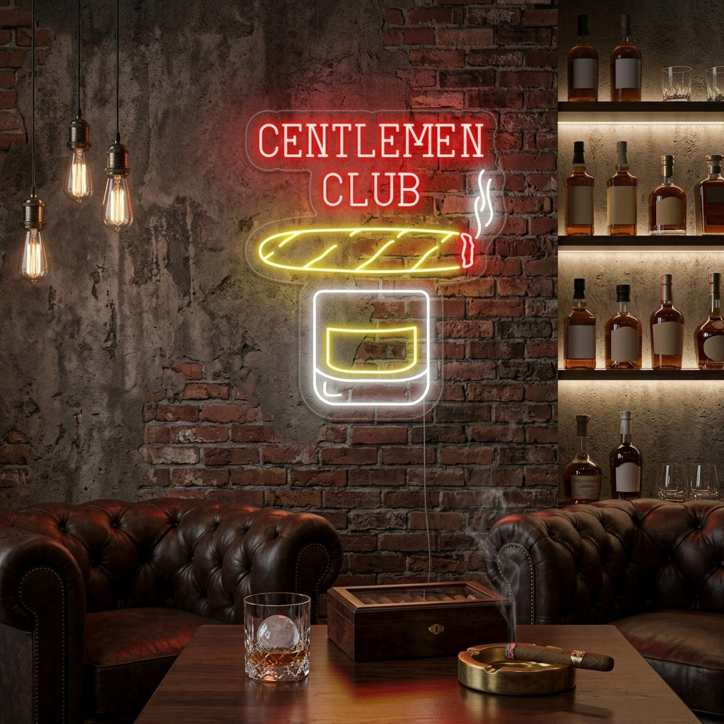 A cozy, vintage-style home bar or man cave corner featuring dark wood shelving stocked with premium whiskey bottles and cigar humidors. Above the bar is the glowing red and amber neon sign featuring text: 'Gentlemen Club Whiskey Cigar' with small illustrations of a whiskey tumbler and a lit cigar. The scene captures a warm, inviting atmosphere with shadows and a worn leather chair.